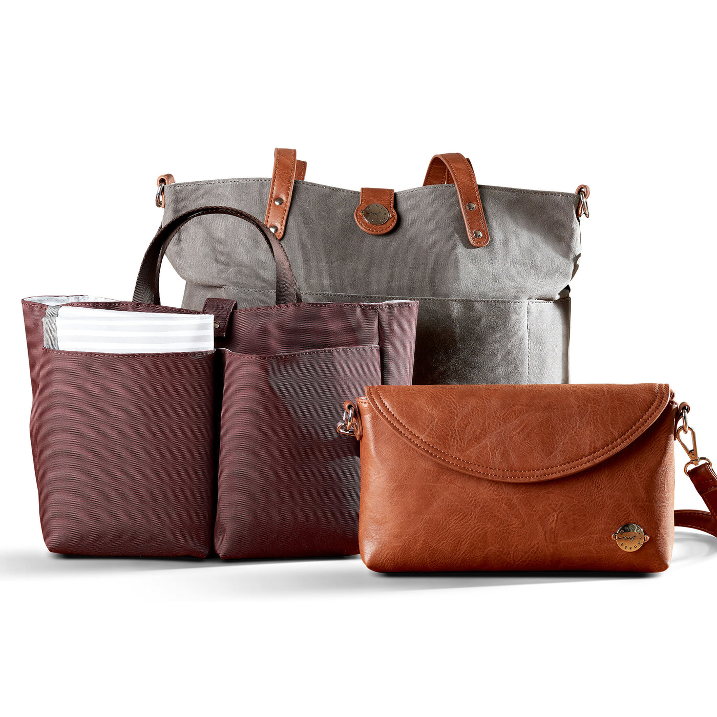 Grey Carry All Tote Trio shown with three included components; grey waxed canvas tote with brown vegan leather accents, brown vegan leather diaper clutch and burgundy multi-pocket organizer insert with carry handles.