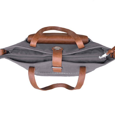 Top down view of grey canvas CarryAll Tote bag with caramel brown vegan leather accents, zip closed on white background.