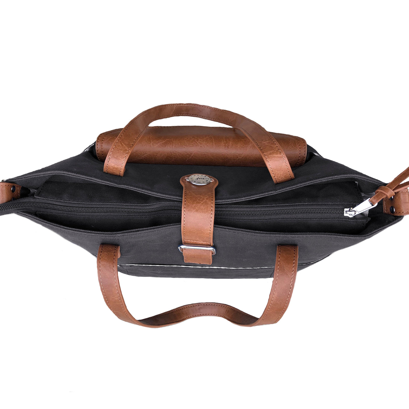 Top down view of black canvas tote bag with brown vegan leather accents with closed zipper top.