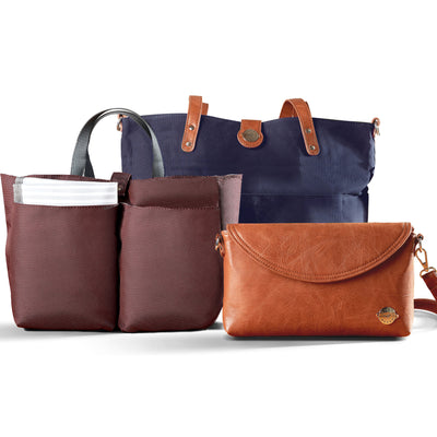 Navy Blue CarryAll Tote Trio shown with three included components; navy waxed canvas tote with brown vegan leather accents, brown vegan leather diaper clutch and burgundy multi-pocket organizer insert with carry handles.