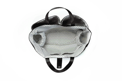 A series of images in GIF format showing a black Organizer Insert with white polka dot lining being loaded full of baby items, from empty to full.