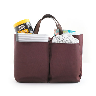 Burgundy colored polyester diaper bag insert filled with diapers, wipes, snack container and changing pad.