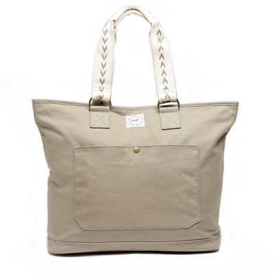 Large capacity Rye (tan) colored canvas tote with off-white carry handles that have tan accent stitch.  Front pocket has brass snap closure.