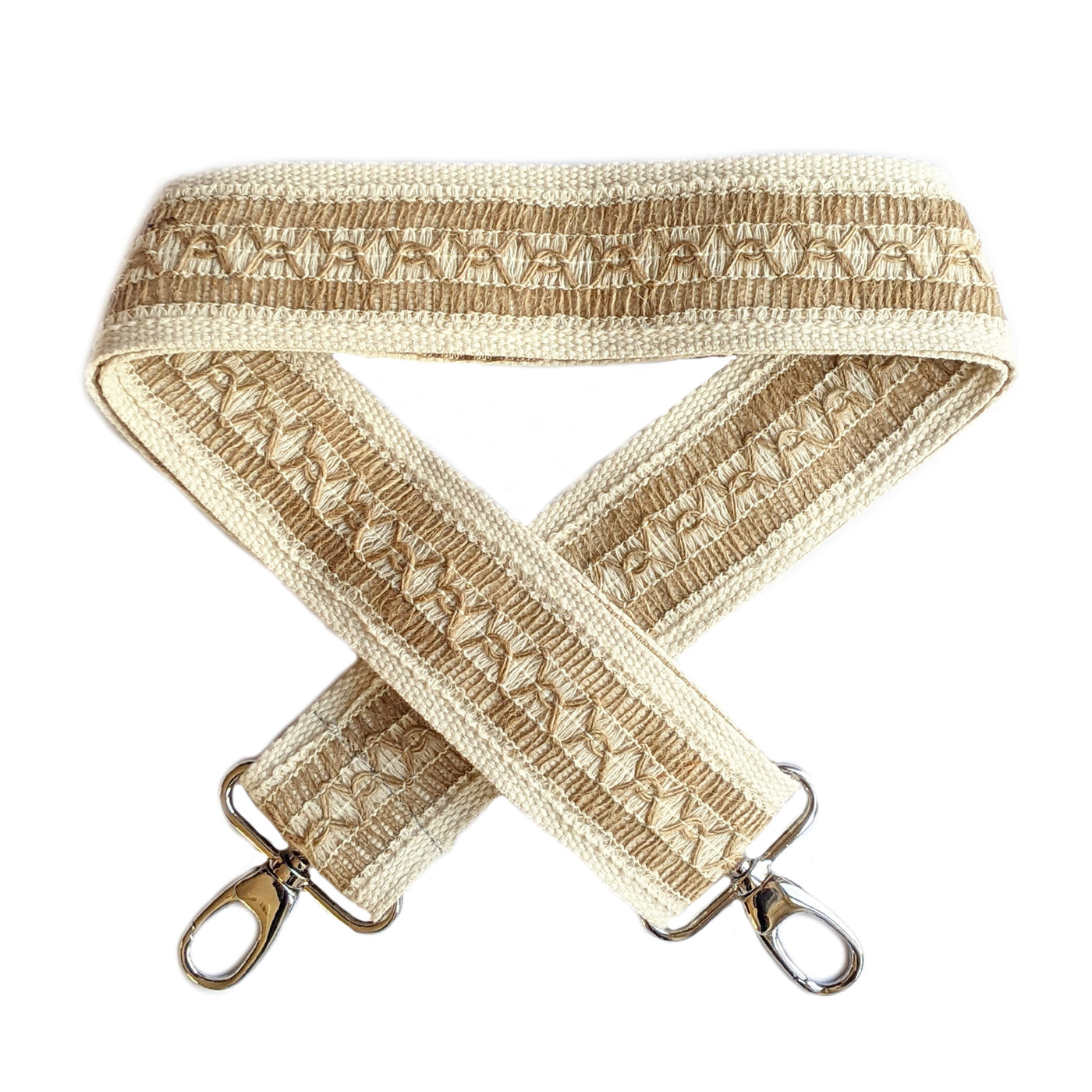 A close-up on white background of an adjustable length, woven bag strap with a two tone beige pattern and silver clasp.