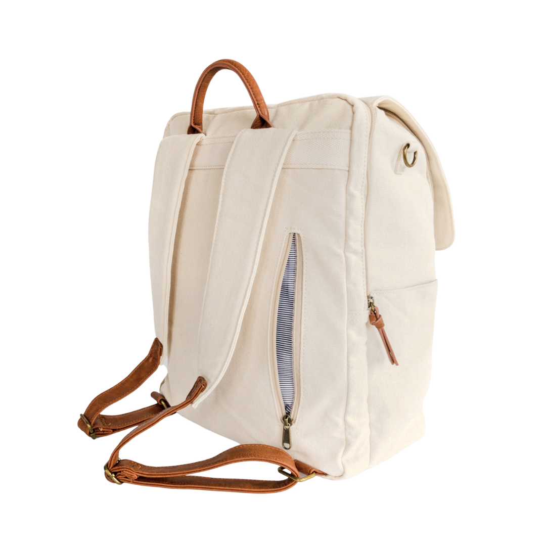 A back-facing 3/4 view of stone colored canvas backpack that shows zip-close back pocket in open position that conveniently stores items that need to be easily accessible.Side water bottle pocket and separate padded laptop pocket that has a zipper closure also shown. Image shown on white background.