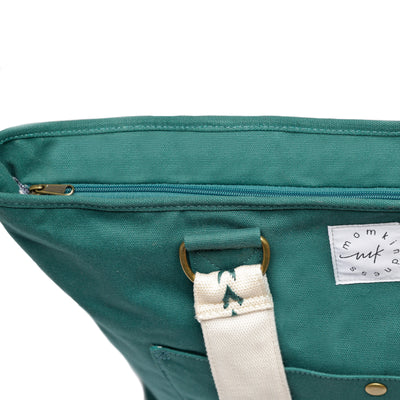 A close-up showing the zip-top closure of a large capacity Juniper green colored canvas tote.