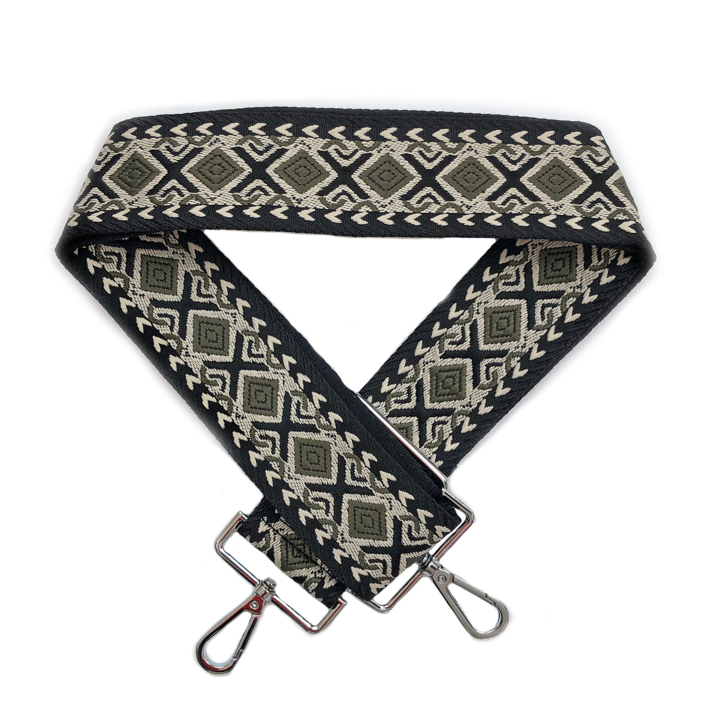 A sage green, black and beige geometric patterned woven bag strap with silver metal buckles, shown laying on a plain white background.